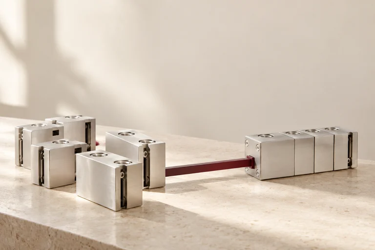 Separate aluminum modules consolidated into one assembly along a burgundy rail.