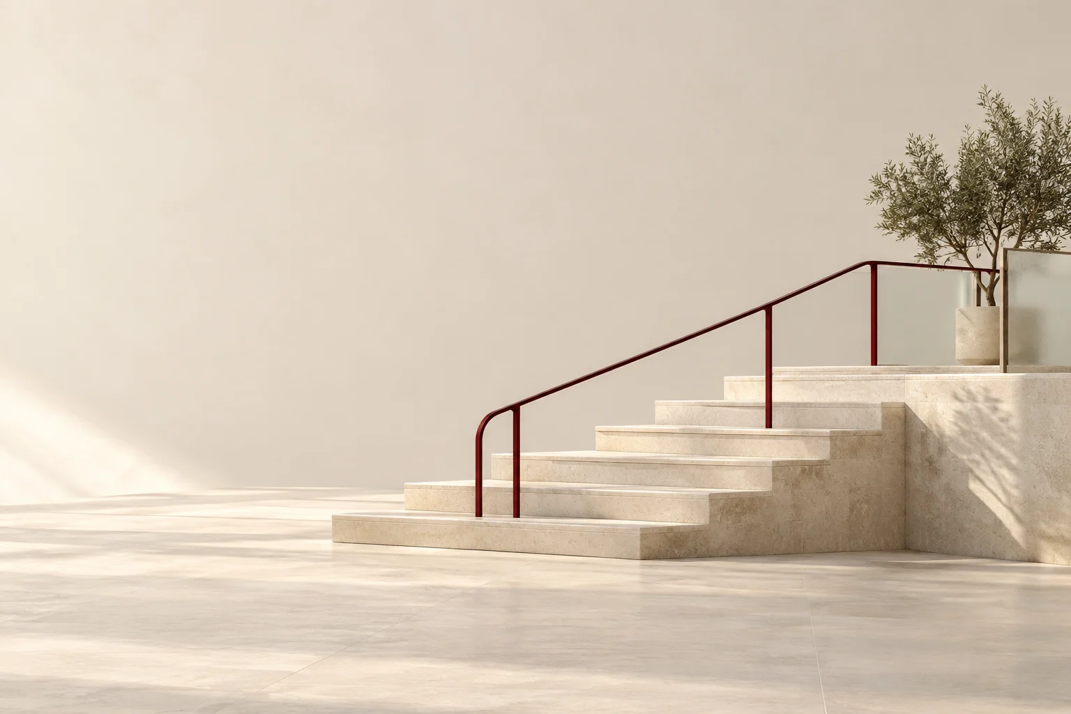 A gently rising stone stairway has a continuous burgundy handrail.