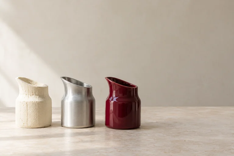 Three stages of a product prototype in foam, metal and burgundy ceramic.