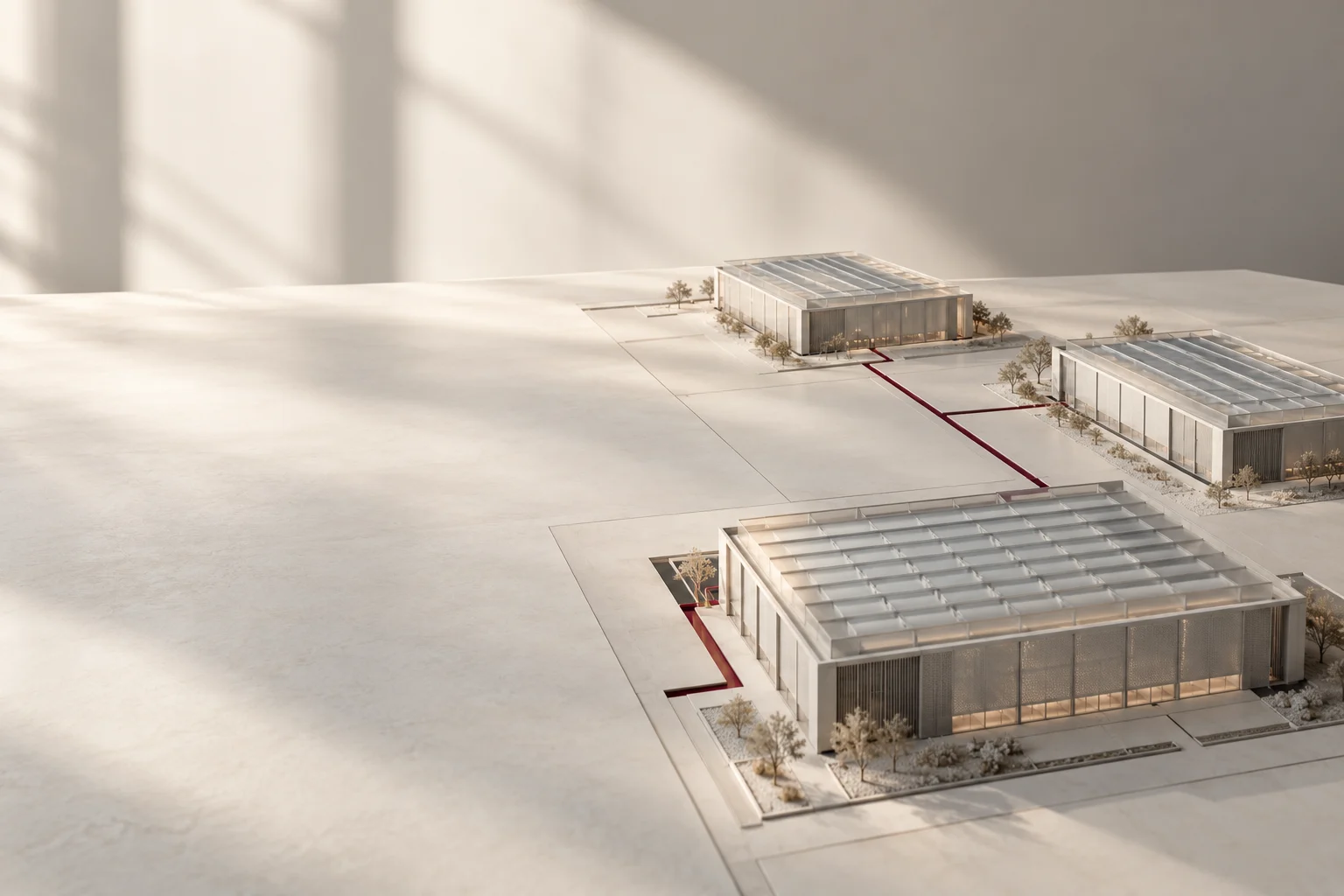 Three data-center building models connected by a burgundy route on a pale architectural model.