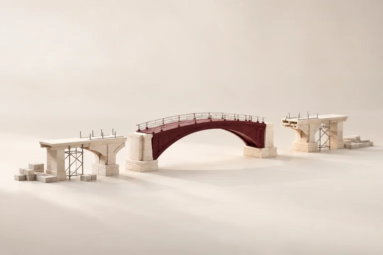 A burgundy bridge span aligns with stone spans on a construction model.
