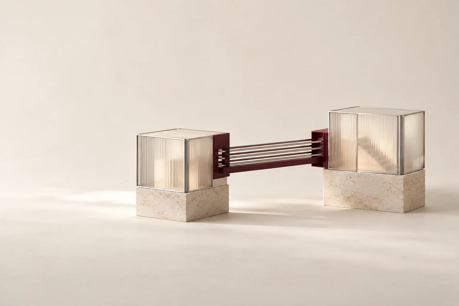 A burgundy bridge connects two glass modules on stone bases.